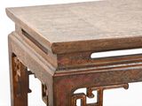 a small wooden table with a carved top