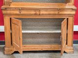 a wooden cabinet with a glass door on top of it
