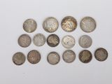 a close up of a bunch of coins on a white surface