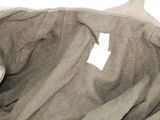 a bag with a tag on it sitting on a bed