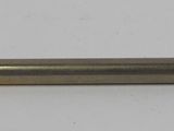 a small metal object with a red handle on a white surface