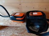 two orange and black items sitting on a wooden bench