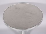 an image of a silver metal table with a round top
