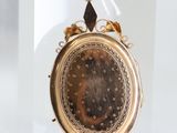 a gold locke with a picture of a woman on it