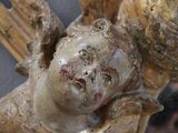 a close up of a statue of an angel holding a ball