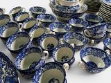 a lot of blue and white plates and bowls