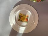 a white plate with a label on it sitting on a table