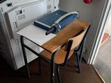 a desk with two chairs and a printer on it