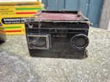 an old black radio sitting on a table next to a box