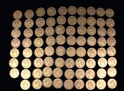 a lot of silver coins on a black surface