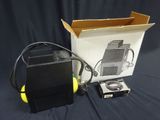 a box with a camera and headphones next to it