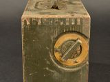 a small metal box with a handle on a table
