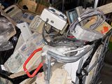 a metal cart full of assorted items on the street