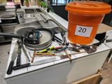 an orange bucket sitting on top of a stove in a kitchen