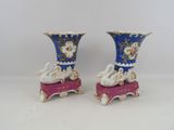 two vases that have swan designs on them