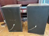 two speakers that are sitting on a wooden floor