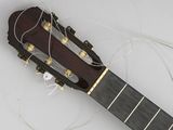 a guitar that is laying on the ground with wires