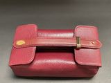 a close up of a red purse on a table
