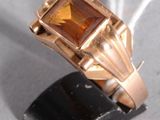 une bague en or sertie d'une pierre orange