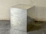a silver box sitting on the floor in front of a wall