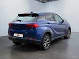 the rear end of a blue suv parked in a garage
