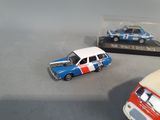 two toy cars sitting next to each other on a table