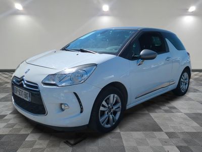 a white citrole is parked in a room with a checkered floor