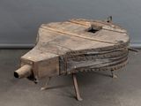 a wooden table with a metal structure on top of it