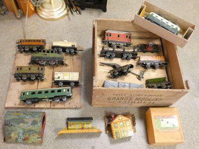 many toy trains in a box on the floor