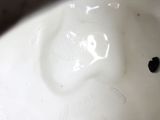 a white sink with a black apple in it