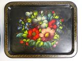a tray with flowers painted on it on a table