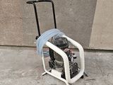 a small air compressor sitting on a cart on the sidewalk
