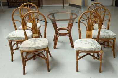 four chairs and a table with a glass top