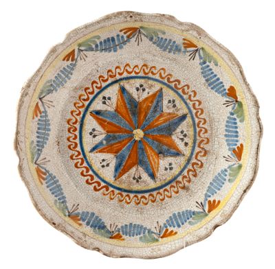 a small decorative plate with a flower design on it