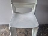 a white chair that is sitting on the floor