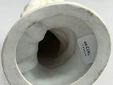 a close up of a white vase with a label on it