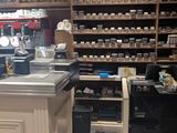 a kitchen with a counter and shelves full of food