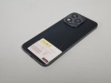 the back of a black phone with a card attached to it