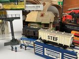 several toy trains are sitting on a table next to a book
