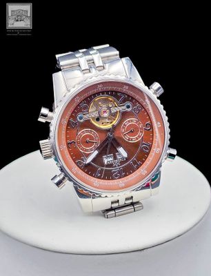 a close up of a watch on a white plate