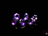 purple amethorate gems on a black background