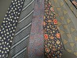 many ties that are lined up together on a table