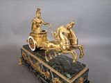 a statue of a woman riding in a carriage with a man on it