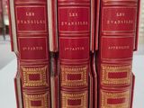 three red books are stacked on top of each other on a table