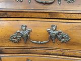 a close up of a wooden chest of drawers with metal handles