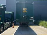 two trucks that are parked in front of a building