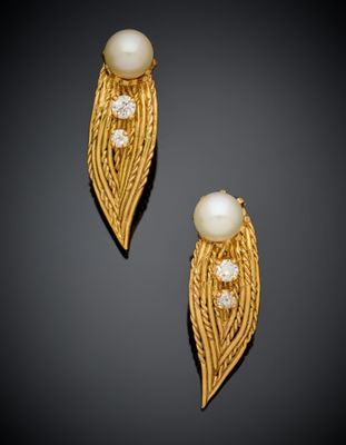 a pair of pearl and gold earrings