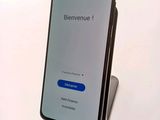 the back of an iphone with a blue button on it