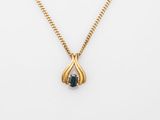a gold necklace with a blue sapphire stone on a gold chain