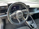 steering wheel and dashboard of a car in a parking lot